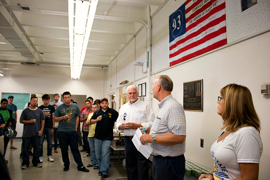 Below a flag signed by his family and a plaque bearing his likeness, students, faculty and staff remember Jason Dahl, alumnus and captain of UA 93 Speech about Captain Jason