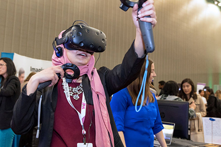 person in vr goggles reaches out, interacting with equipment